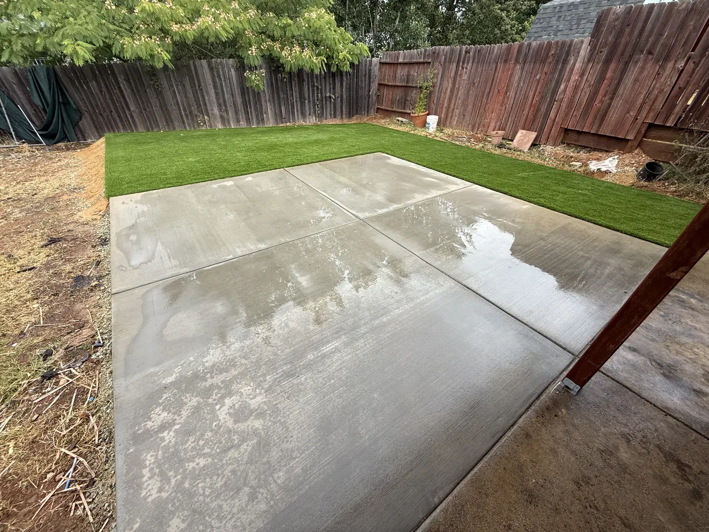New concrete patio beside artificial turf