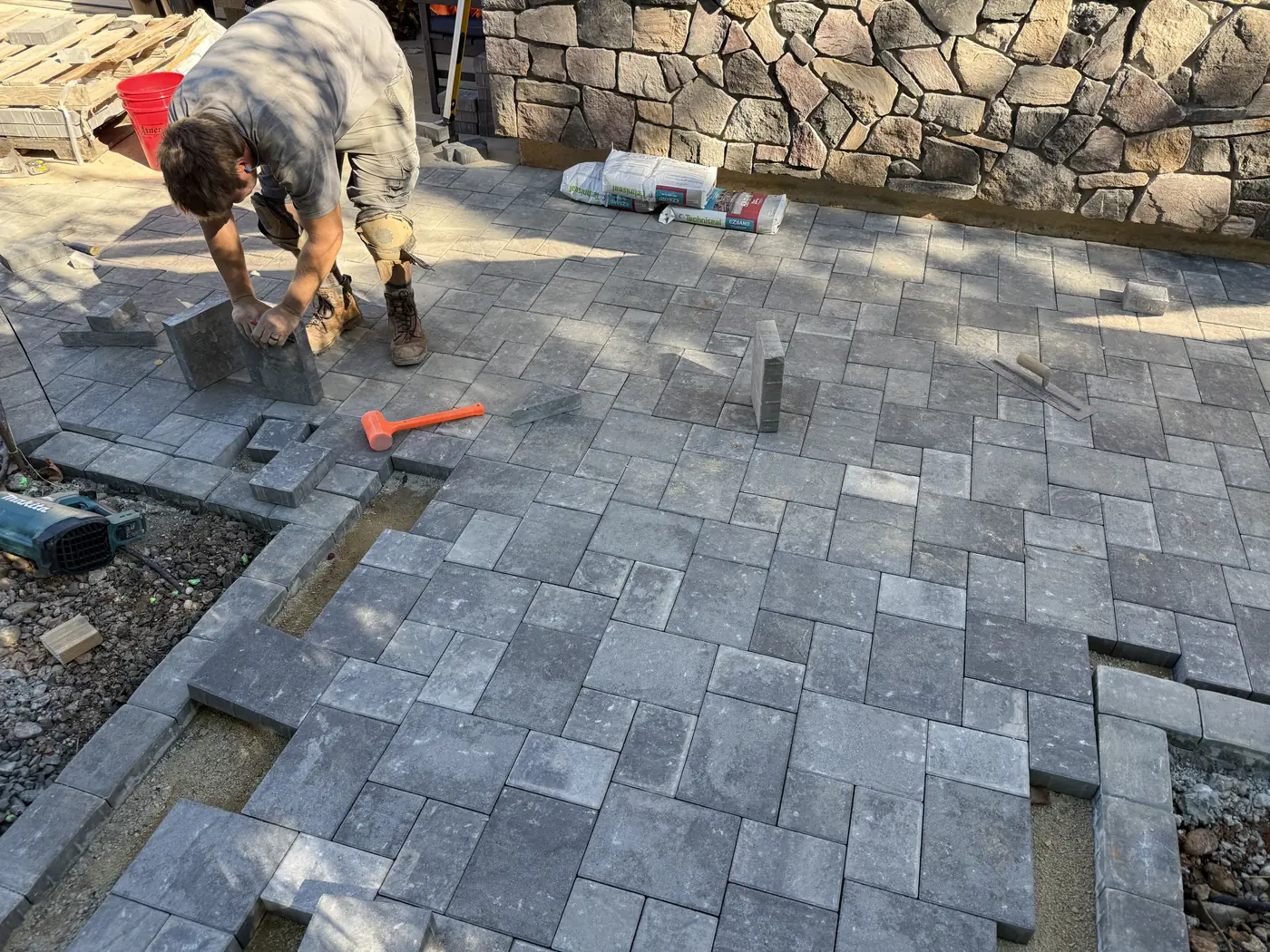 Our crew setting pavers on a new patio