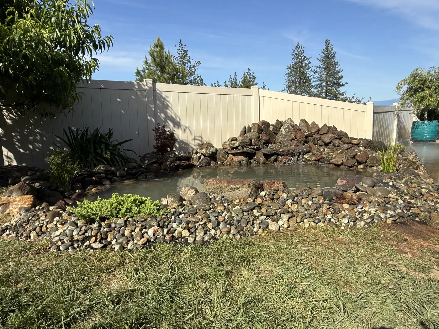 Backyard pond edged with river rock