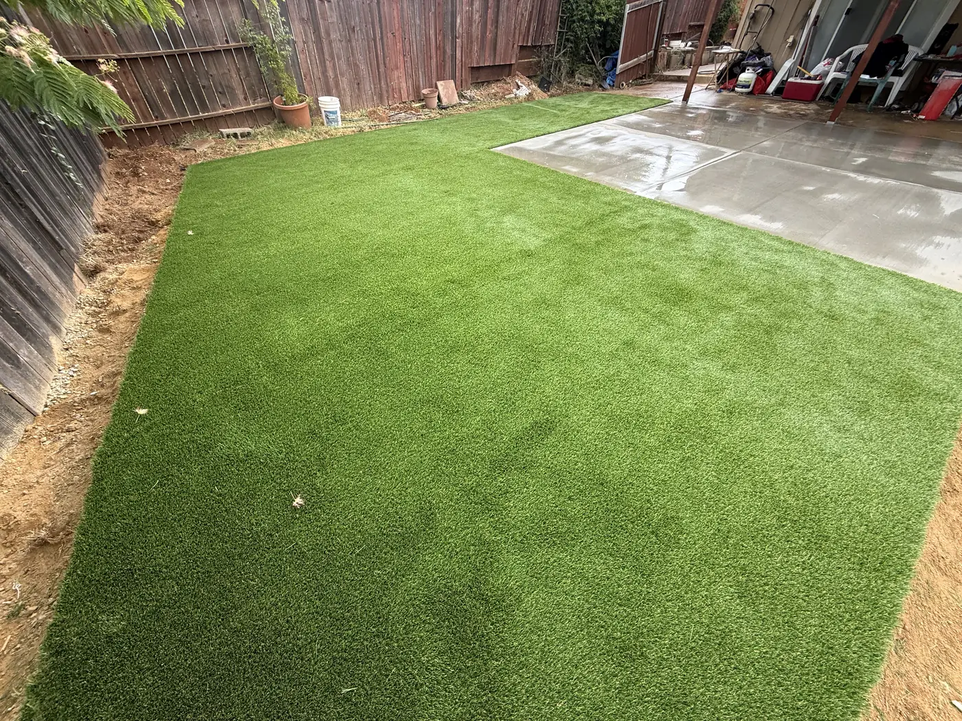 Artificial turf lawn next to a concrete patio