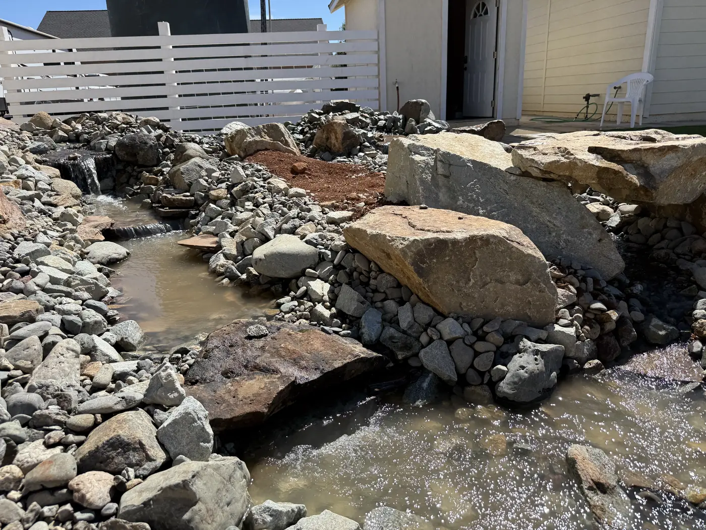 Rock stream bed and boulders built in a backyard